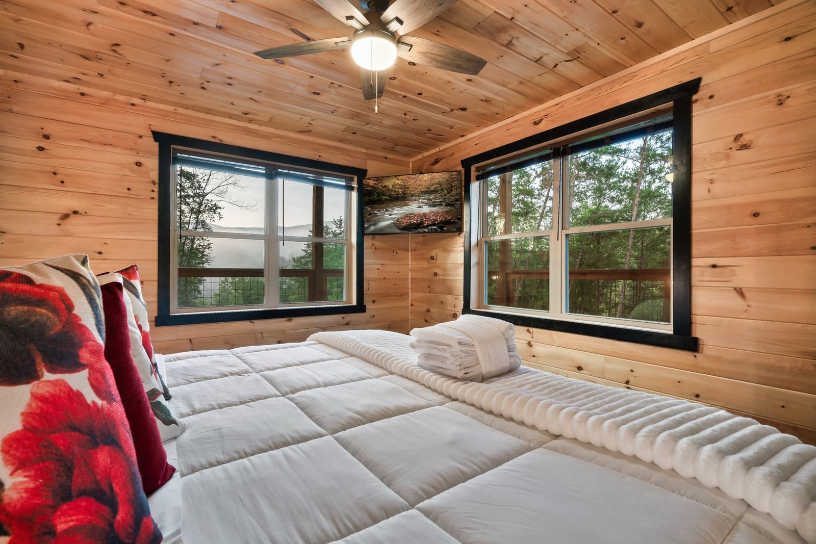 Main-floor king suite at Stay Wild Cabin, offering private space for adults traveling with family or larger groups.