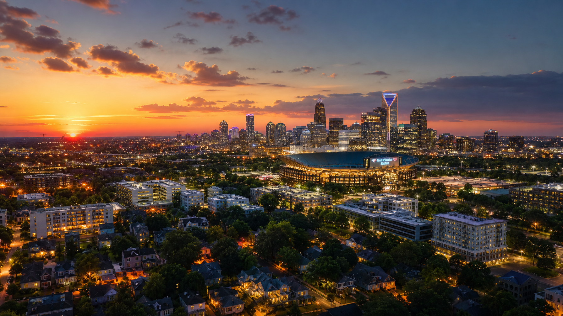 Aerial cinematic view of an American city at dusk with a large stadium and residential vacation rental properties in the foreground