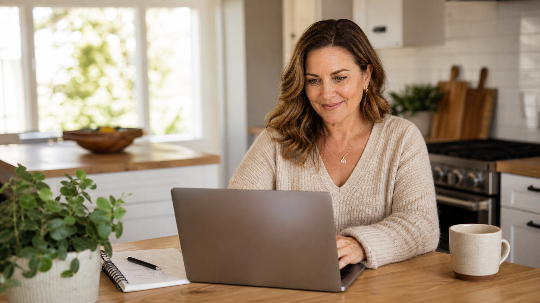 Female vacation rental host personalising an anniversary inquiry response on a laptop to improve booking conversion