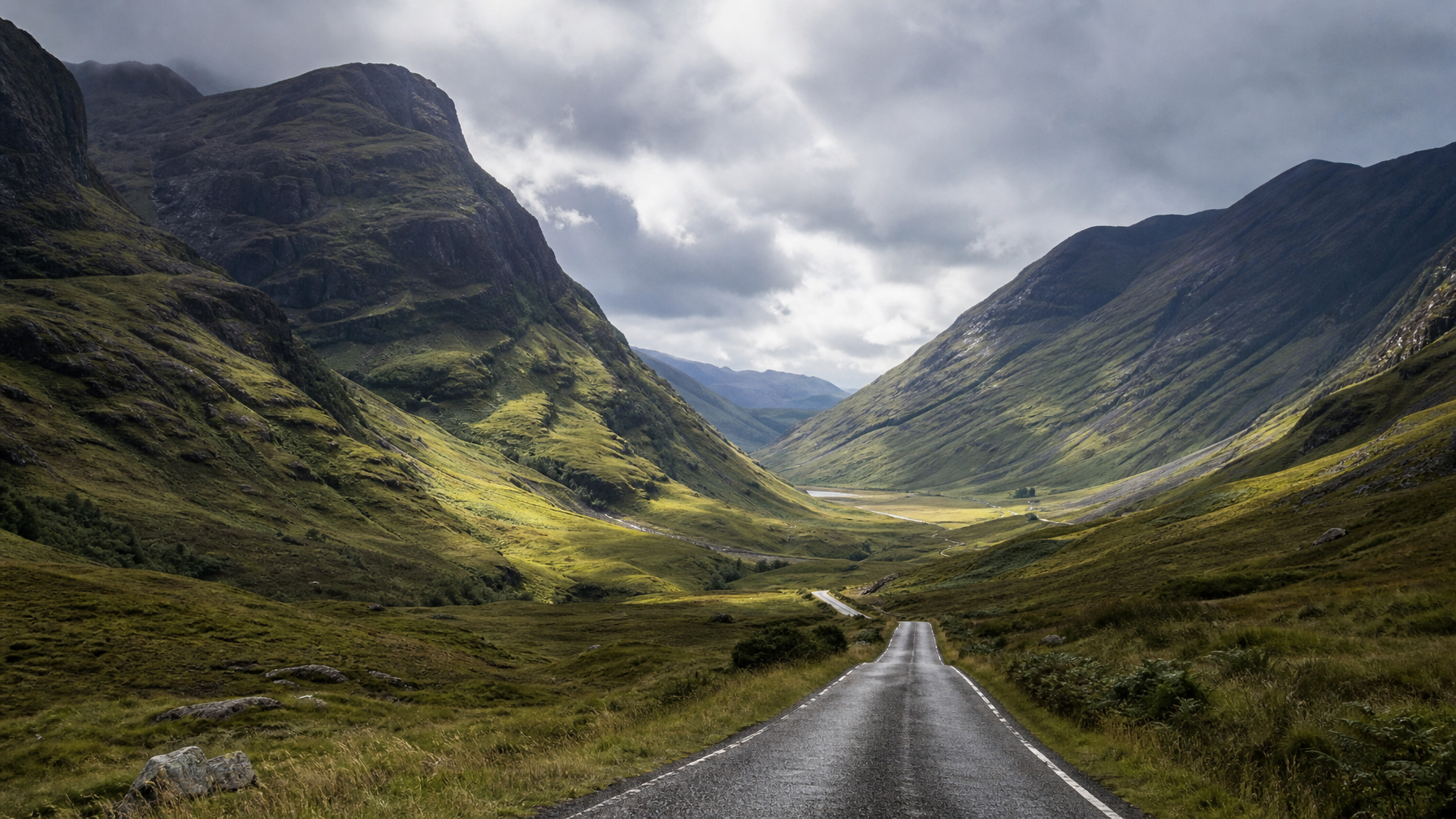 Dramatic Glencoe valley light over an empty Highland road near vacation rentals