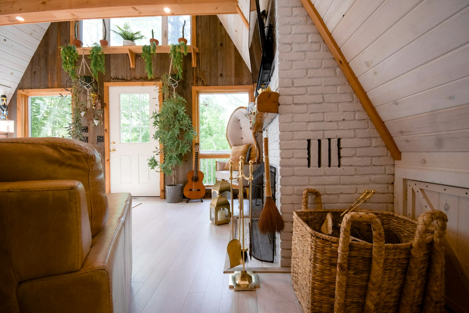 A warm, welcoming living room in a vacation rental with a wicker armchair and guitar