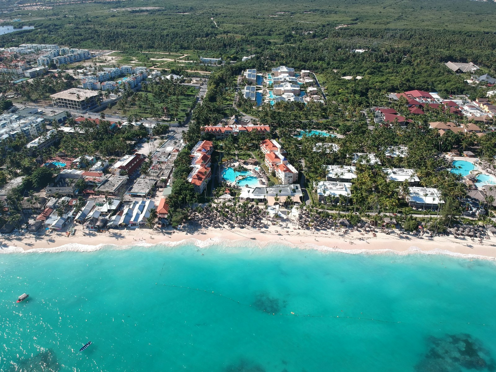 Aerial view of beachfront holiday properties beside the sea