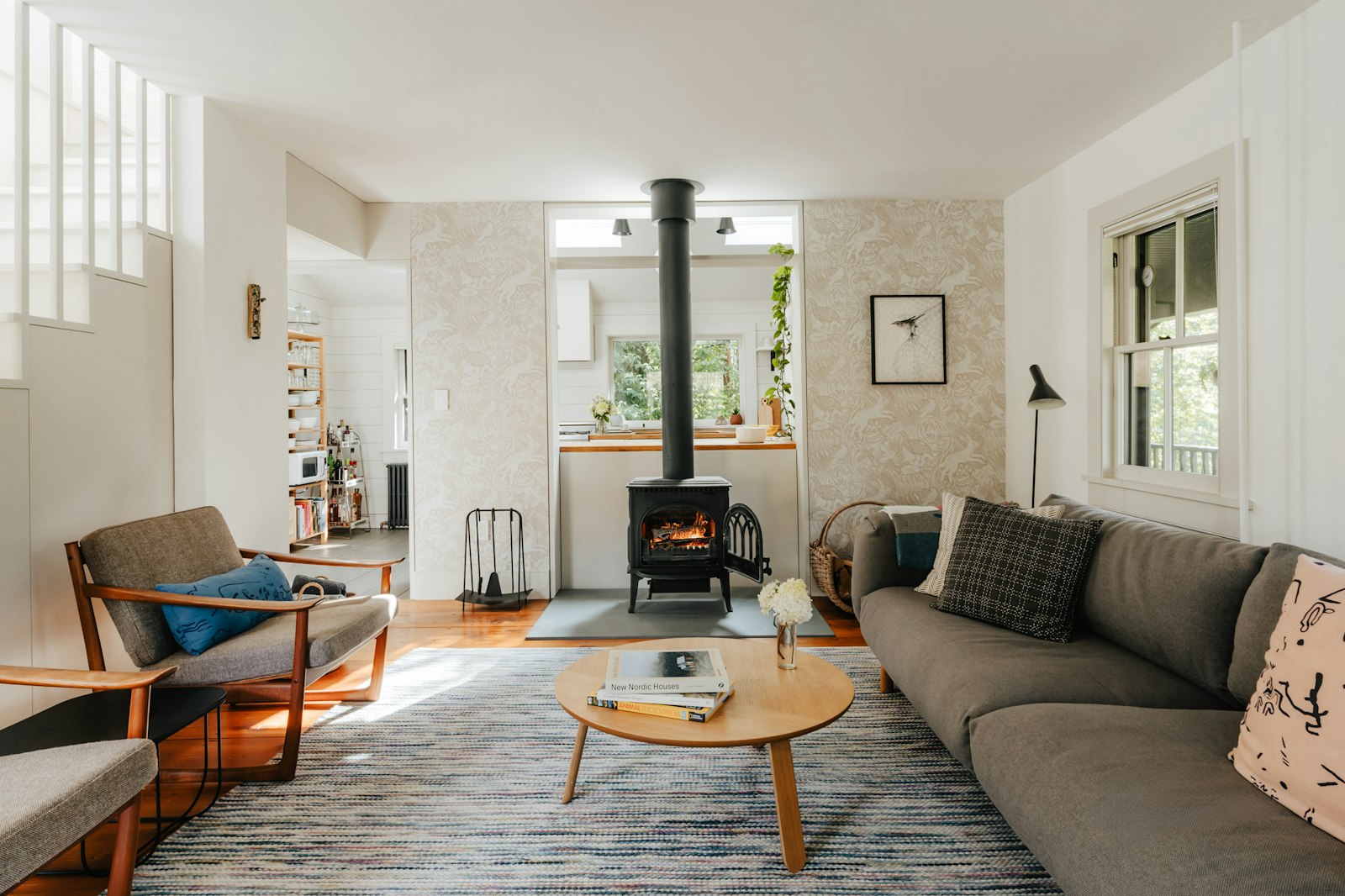 The living room of a whole-home vacation rental with a fireplace and seating for a group