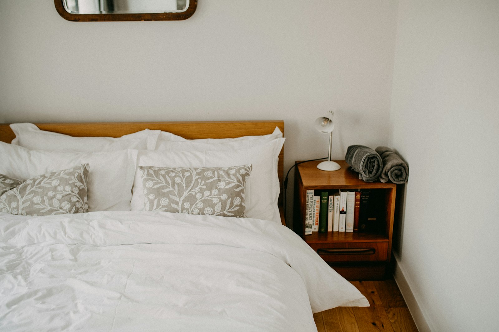 Neatly made bed in a freshly cleaned guest bedroom, the work a cleaning fee pays for