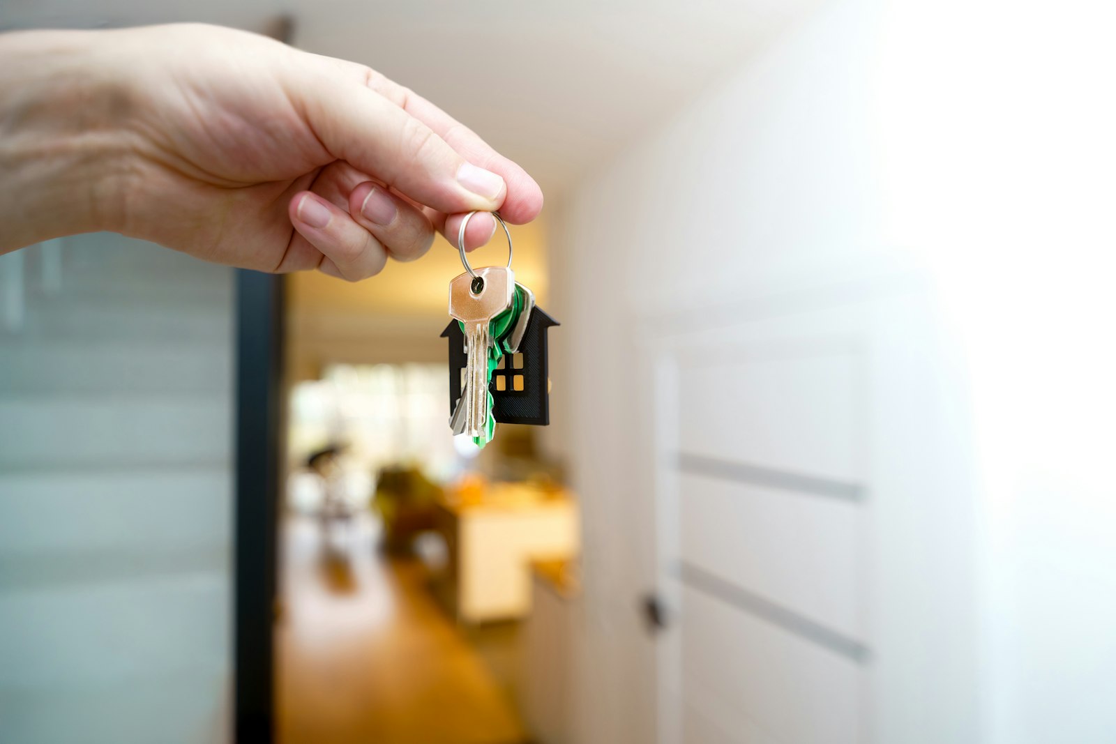 Host holding the keys to a holiday home at the front door, ready for a direct-booked guest