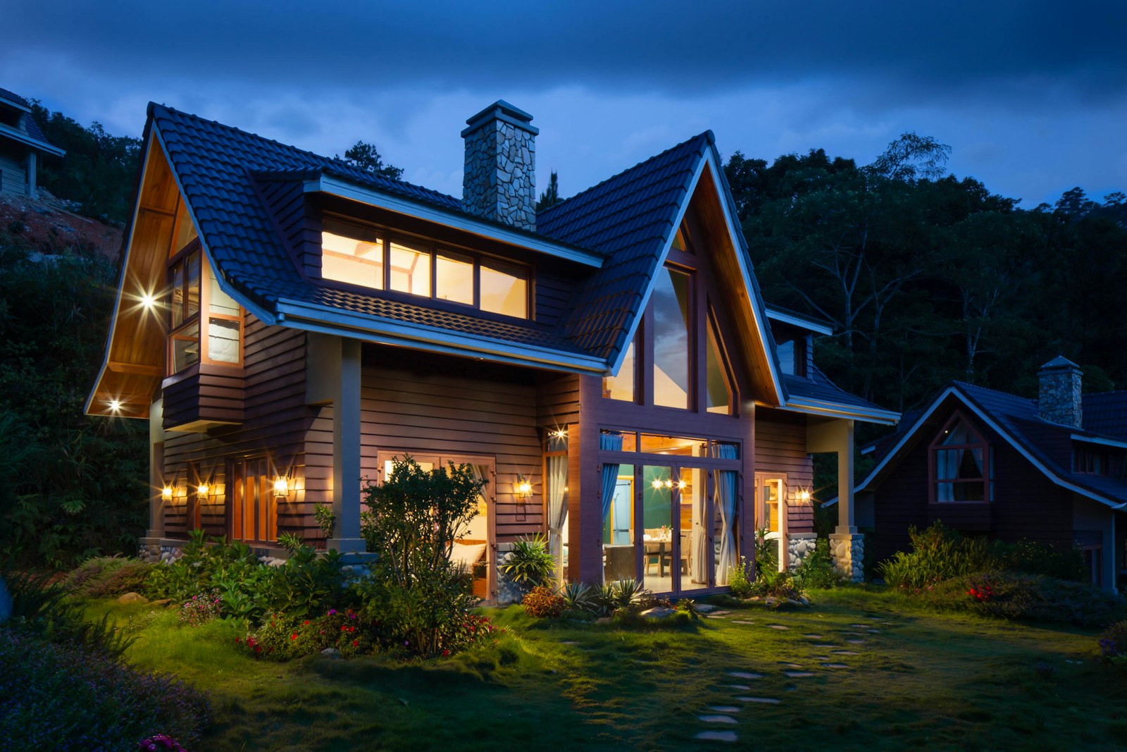 Timber and black-clad holiday house among trees, with bookings already on the calendar