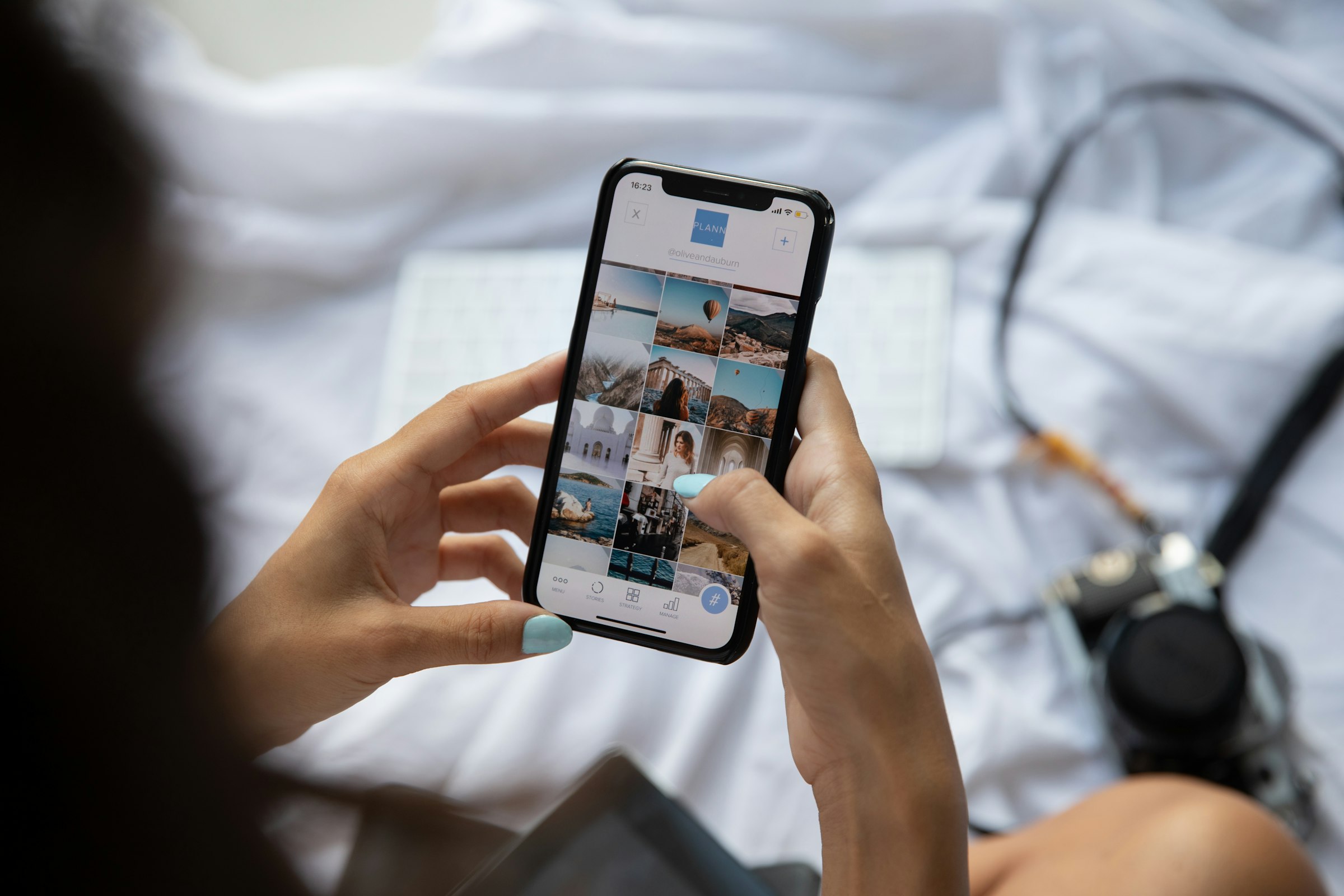 A person holding a phone, looking at the screen