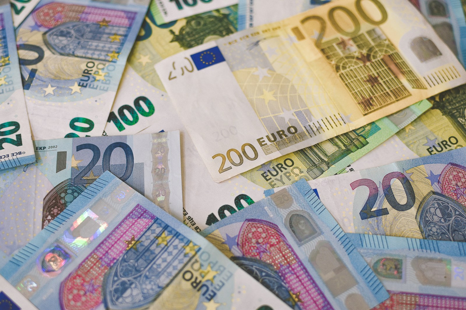 A scattered pile of euro banknotes in 20, 100 and 200 denominations