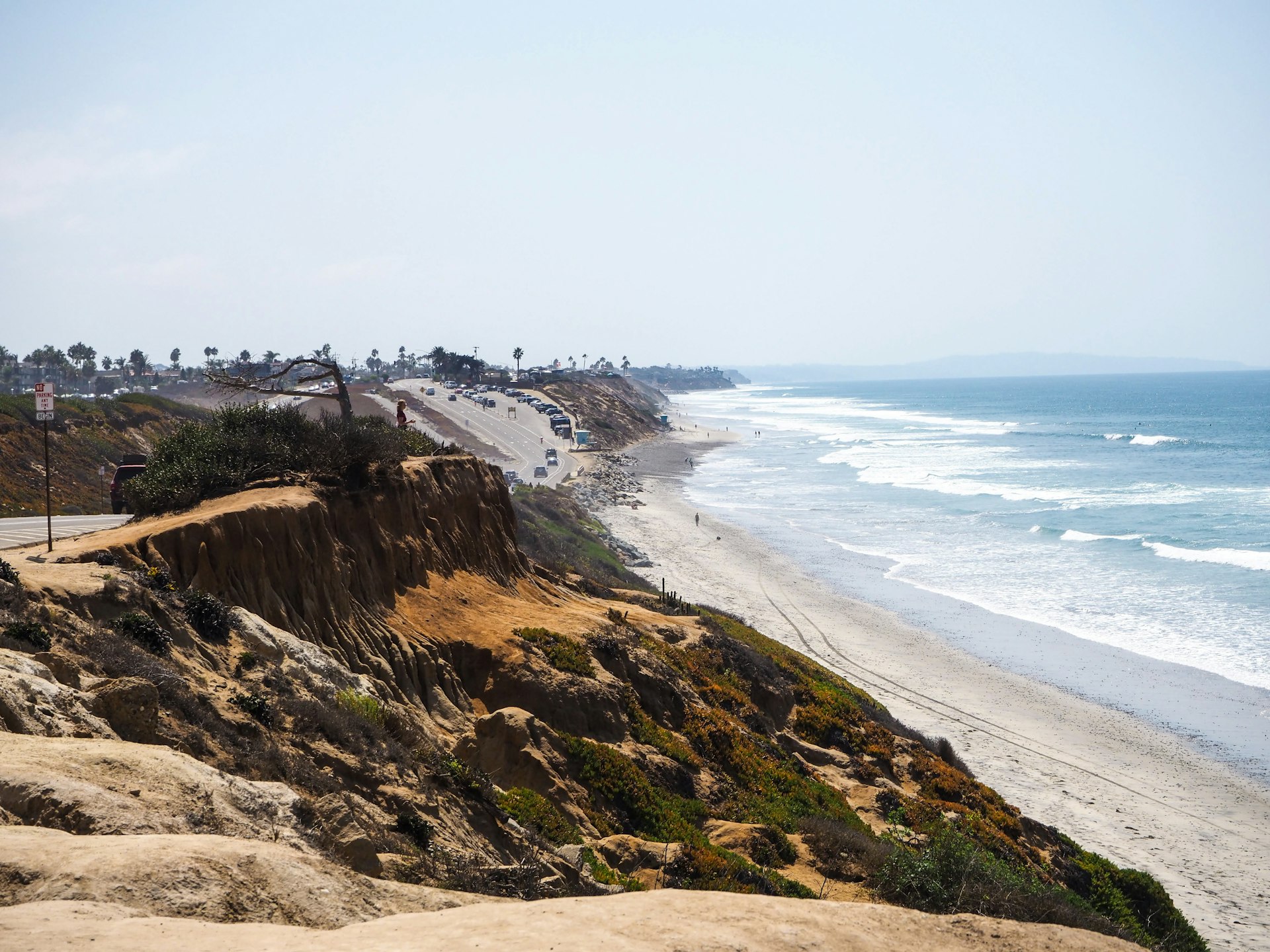 Cliff-top view of the Pacific shoreline and waves at Carlsbad, California