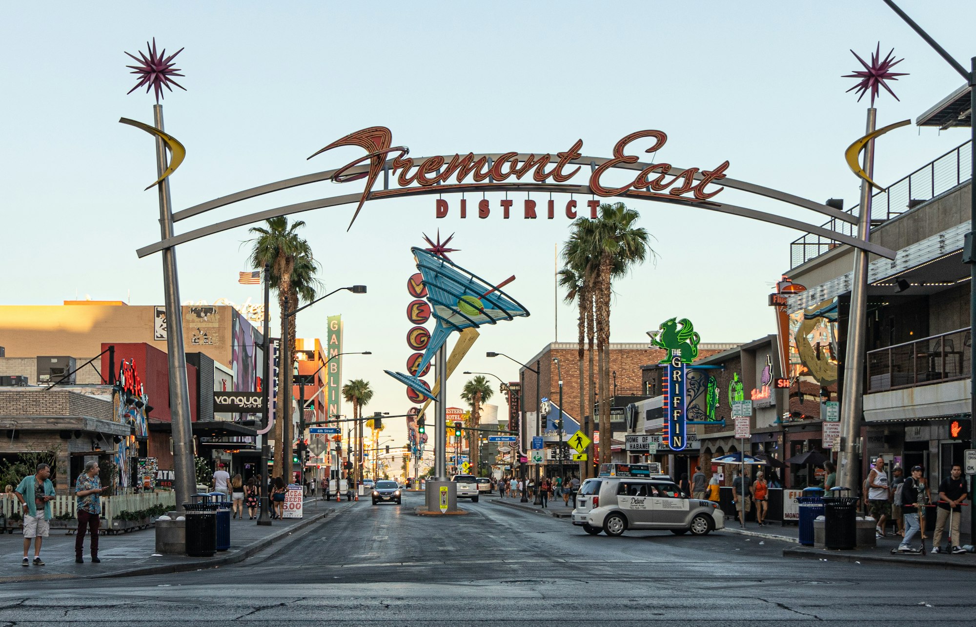 Fremont Street sign and downtown Las Vegas street scene with traffic and casinos