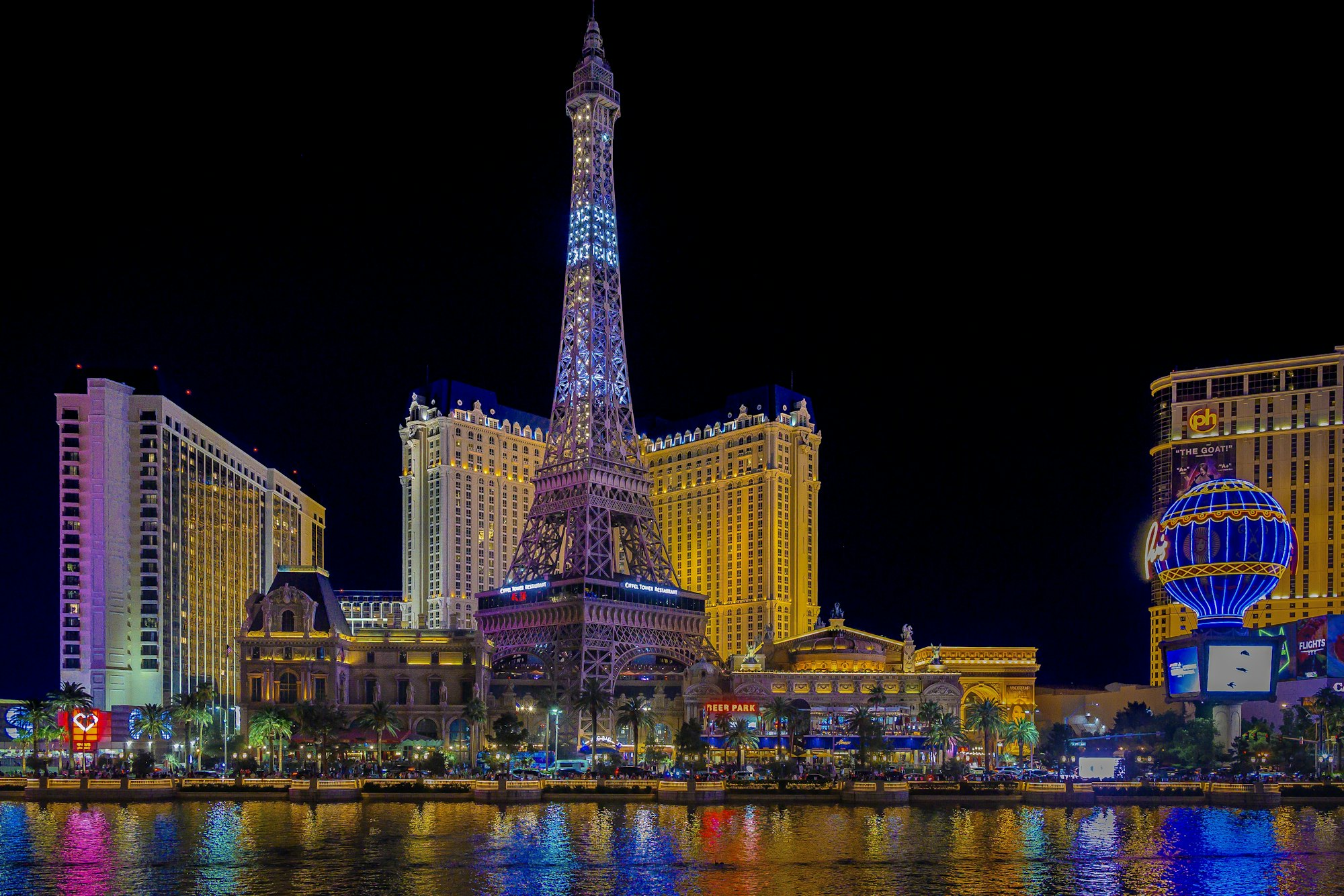 Las Vegas Strip hotel towers illuminated at night along the main corridor