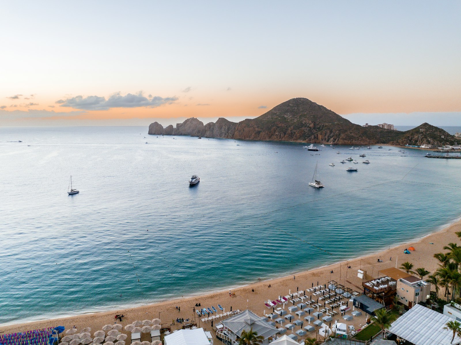 Beach with boats and a hill in the background at Cabo San Lucas