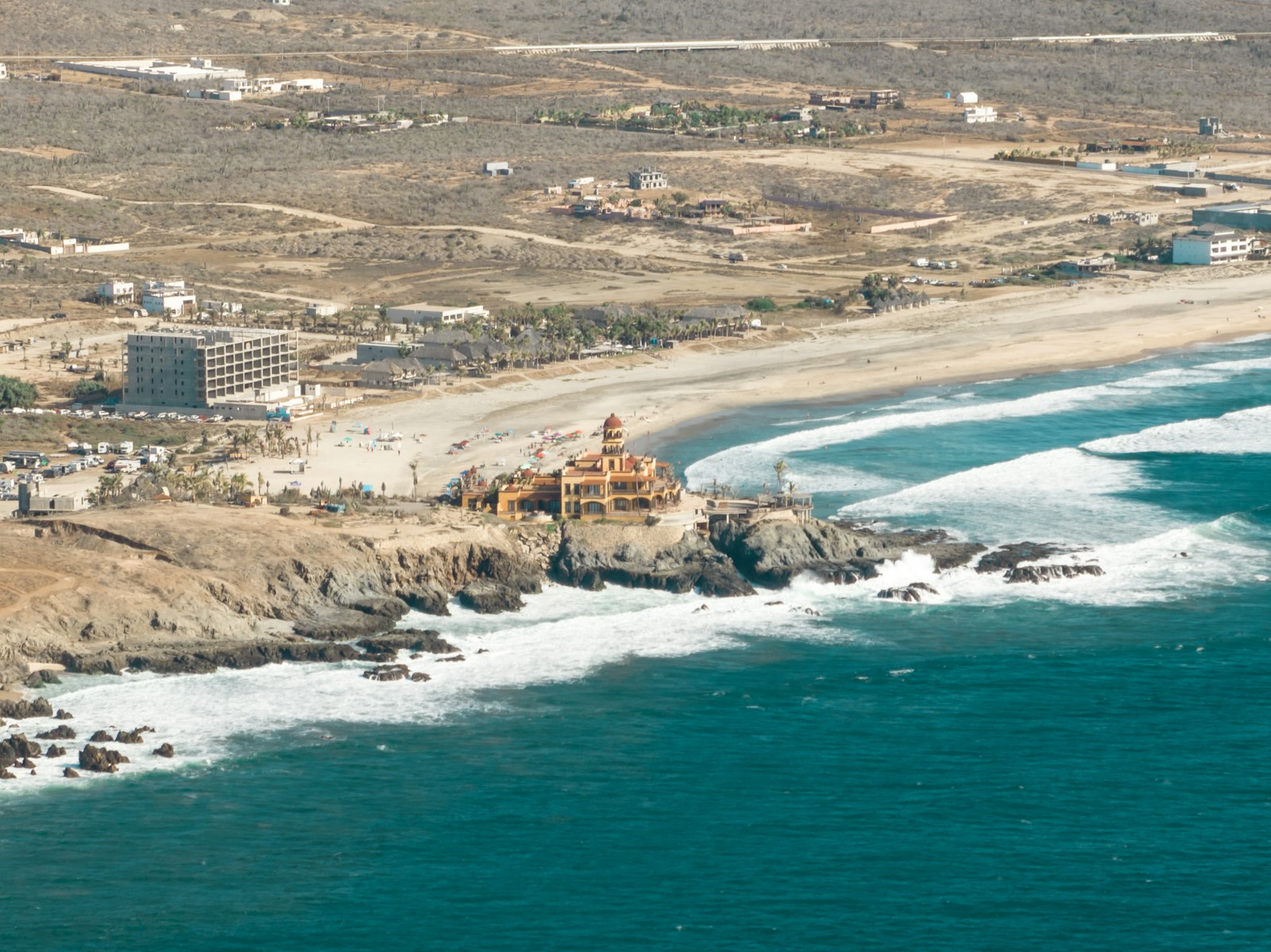 Wide sandy Pacific beach near Todos Santos with surf and open coastline