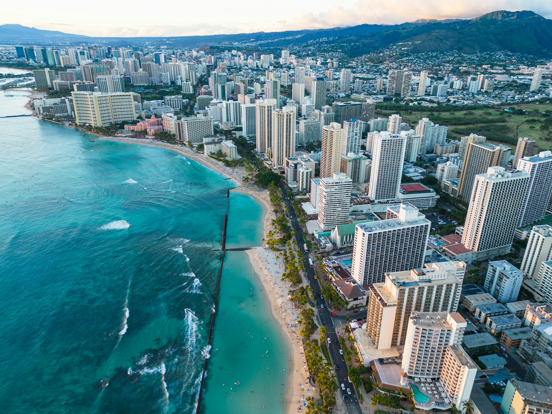 Aerial view of Honolulu high-rises along the coast next to the ocean
