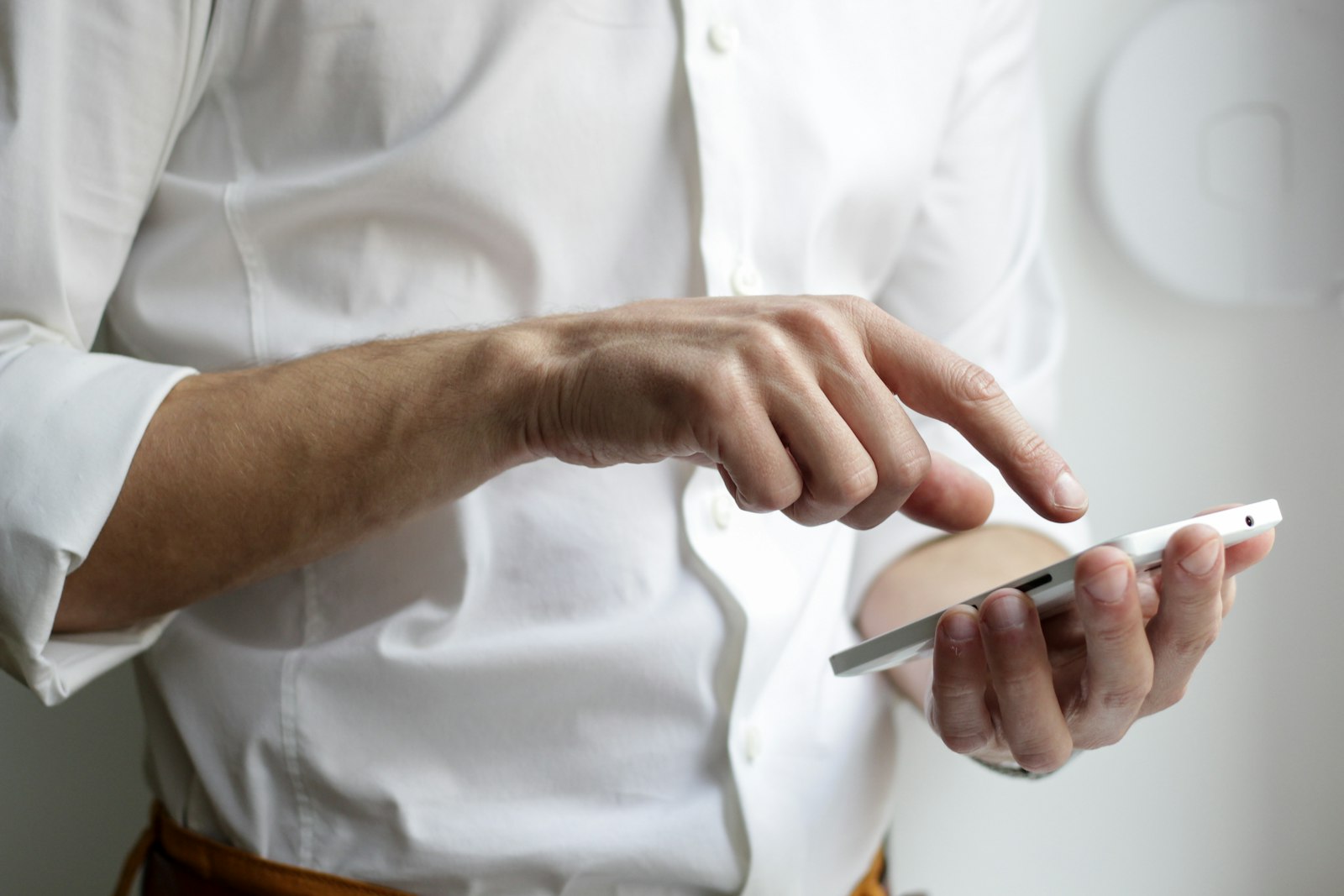 Person holding a smartphone and typing a message