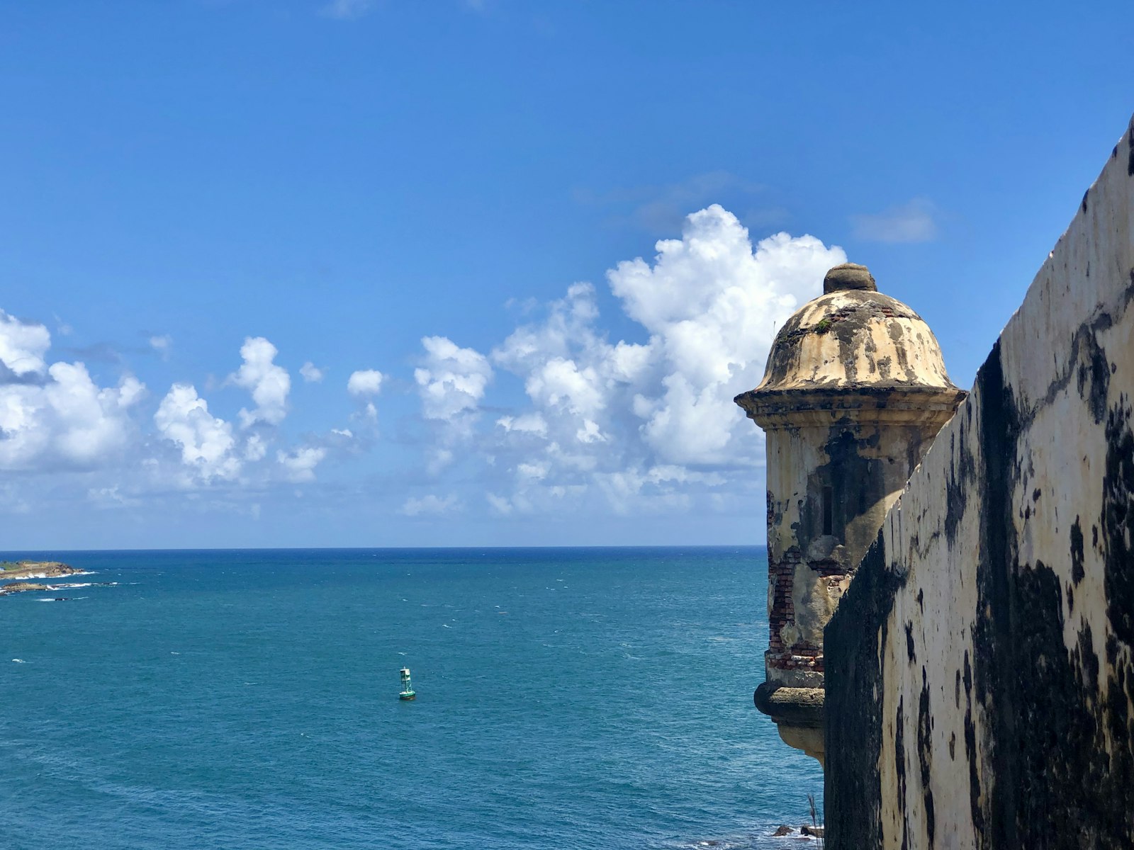 Historic stone fort walls of Old San Juan beside the sea under a blue sky