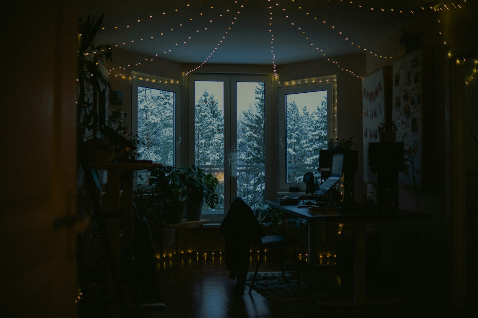 Cozy room with fairy lights and a snowy window view