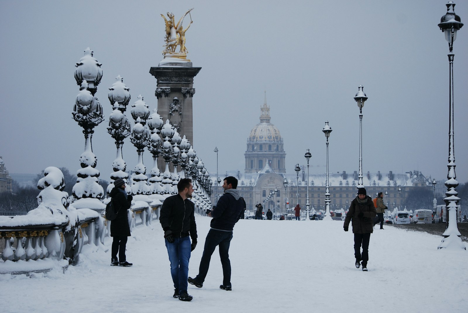 Snow-covered Hôtel des Invalides behind the Alexandre III Bridge in Paris
