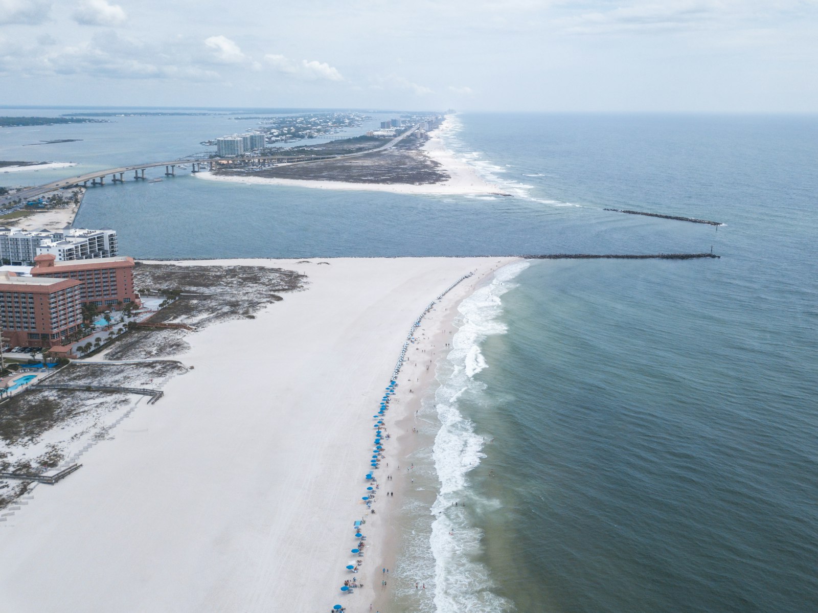 Looking down a quiet Orange Beach shoreline on a sunny winter day