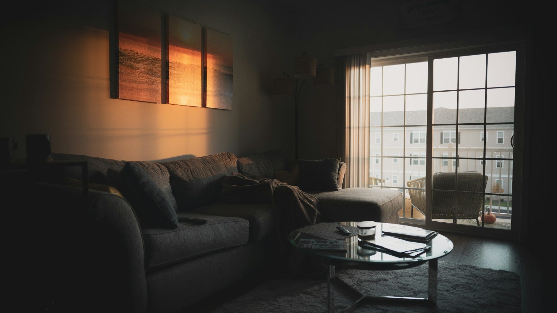 A tidy living room with a sectional sofa, straightened cushions and a coffee table beside a window
