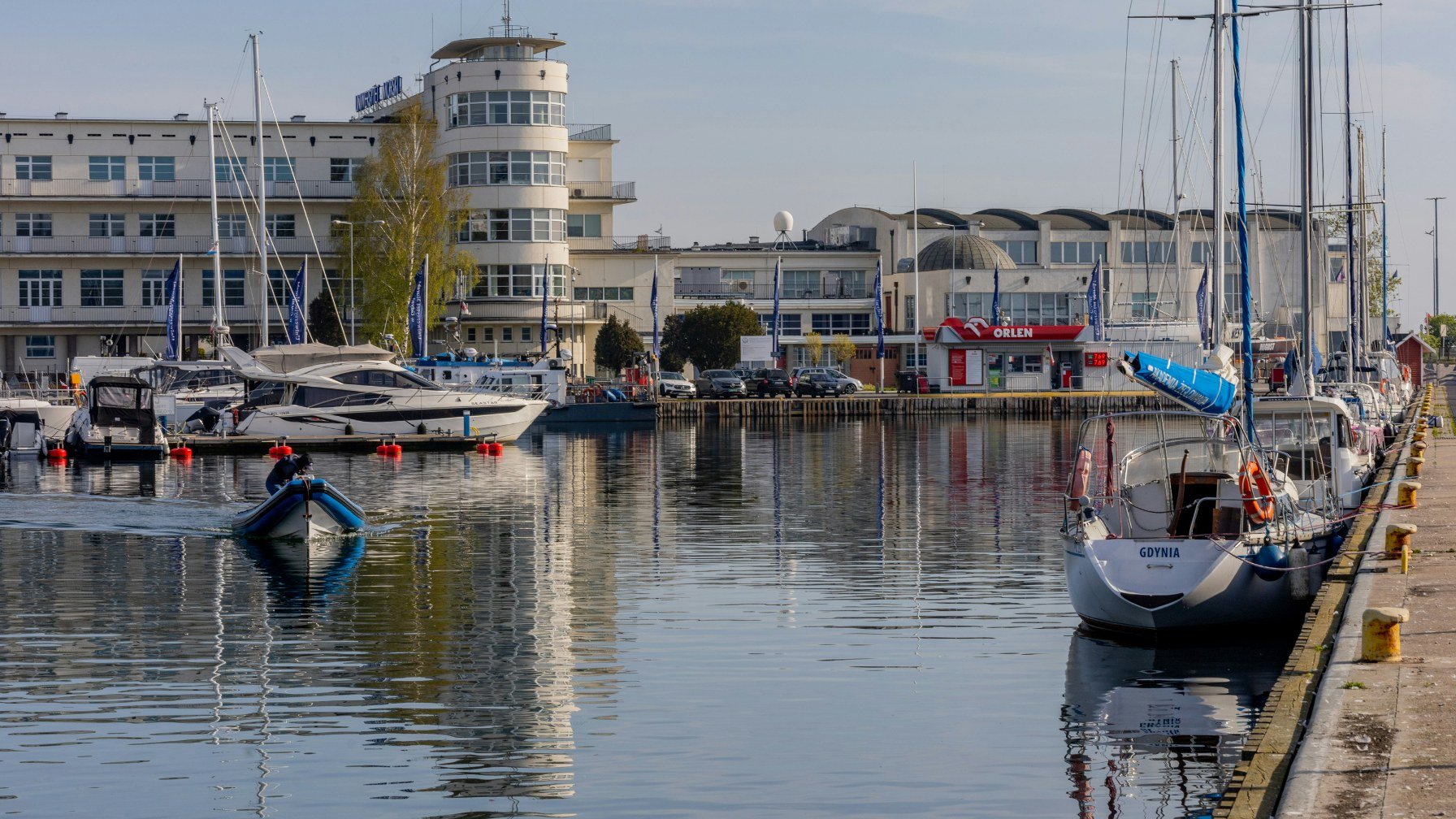 Yachts moored in the marina at Gdynia in front of the white modernist waterfront