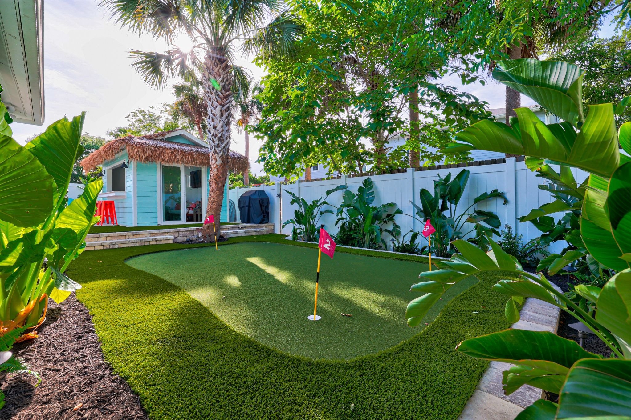 Tropical backyard with pool and tiki bar in Jacksonville Beach