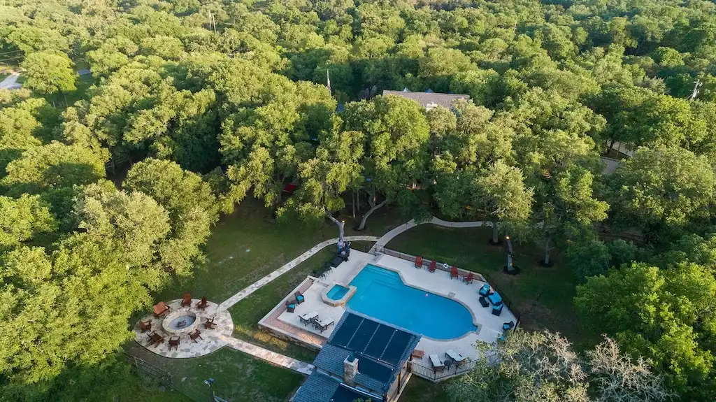 Aerial shot of the backyard entertainment space. Aerial shot of the backyard entertainment space. - Main House at Whispering Oaks Estate - Dripping Springs