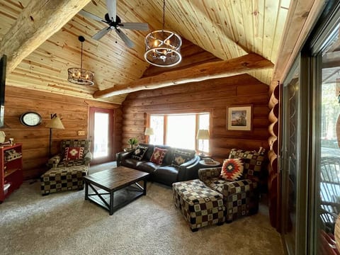 Upper level living room with all new decor and seating, air conditioning, gas fireplace, overhead fans, southern exposure and access to the deck and screened porch.