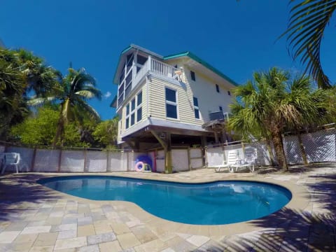 Large private heated pool with expansive lounging space to soak up Florida rays