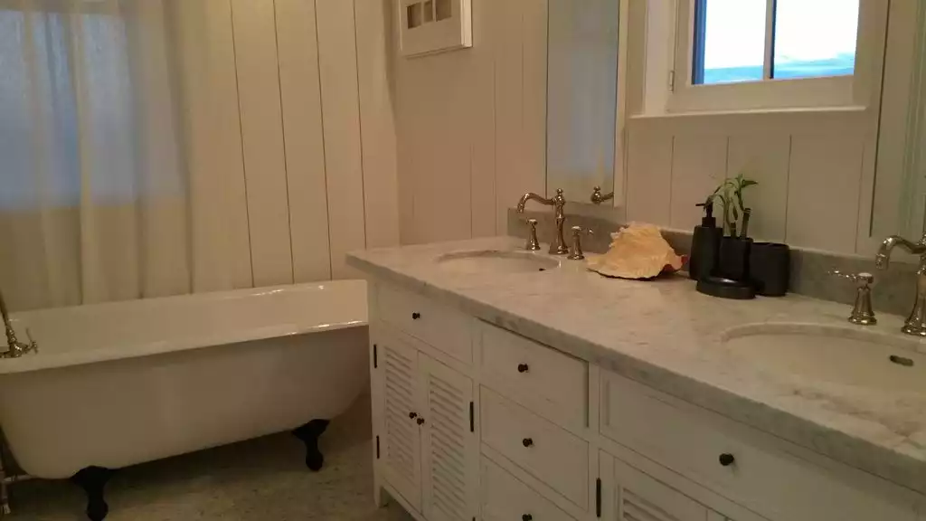 Master bathroom with the cast-iron claw tooth tub - SeaGlass@Beachtown - Galveston