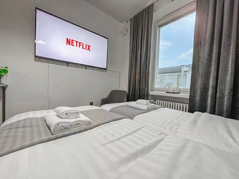 The 65" Smart TV can be watched straight from these comfortable beds.