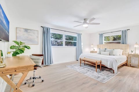 Spacious master bedroom with king bed and desk for remote work or getting ready for the day.