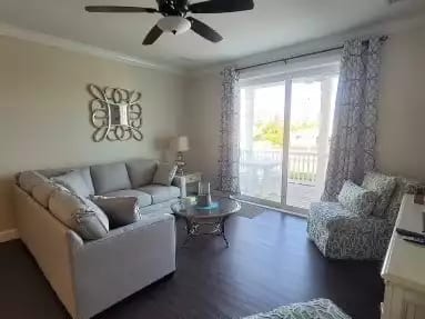 Living room with sectional, two accent chairs and entertainment console.