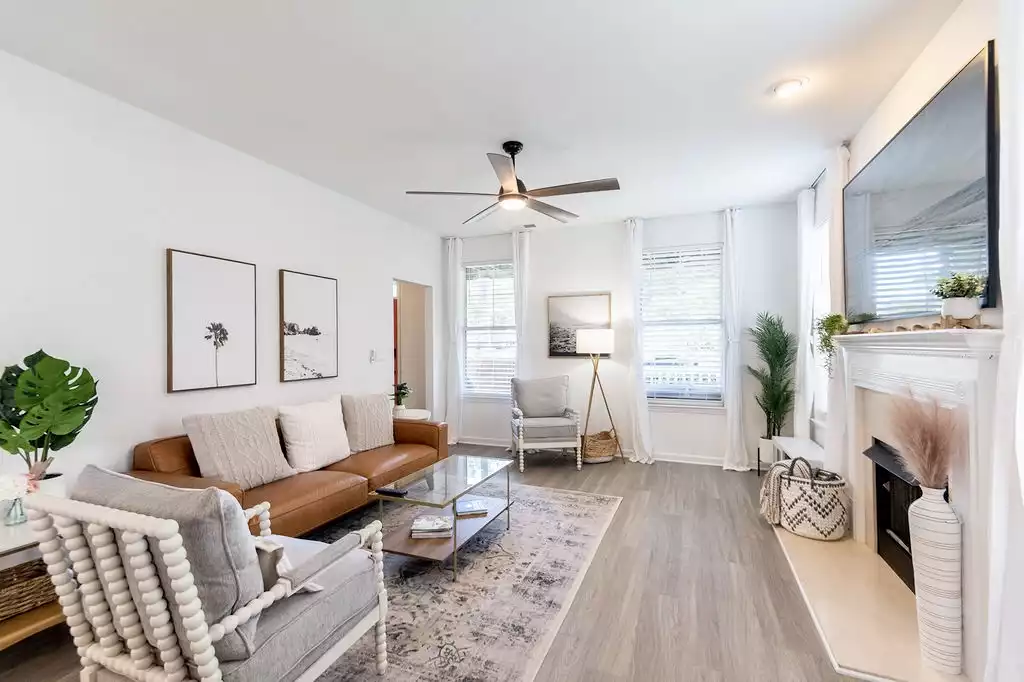 Living room has seating for 5 plus 2 poufs for extra seating