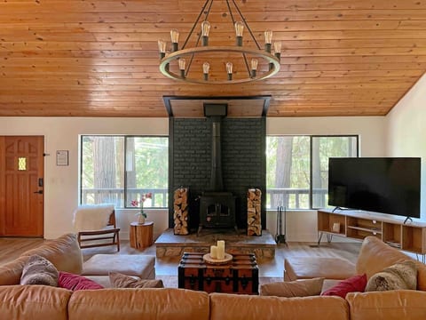 Cozy up on the large sectional sofa and relax near the wood burning stove while you enjoy entertainment on the 70-inch 4K HDR smart TV