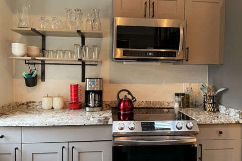 Fully stocked kitchen with new appliances, dishes, pots & pans, and cooking supplies