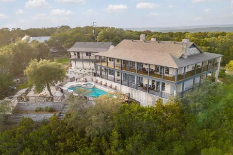 Highlights: 7 beds [4 kings, 3 queens] | 4 full baths | 2 half baths | (heated) pool | hot tub | views | wrap-around deck | kids' playroom | arcade | pool/billiards table | ping-pong table | makeup room 