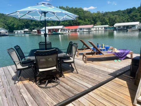 The dock has a table for 6 and 2 lounge chairs