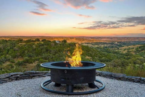 Fire pit overlooking the view of the valley.  Please no fires if wind is over 10 mph/put out flames before retiring for the evening.  Firewood is provided.  There are 8 adirondack chairs for seating around the fire pit.  We also have throw blankets.