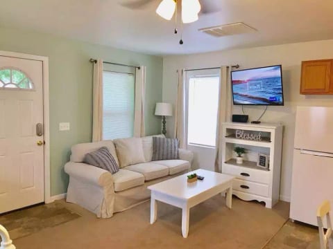 Full sized sofa, coffee table and 43” smart TV with basic cable.