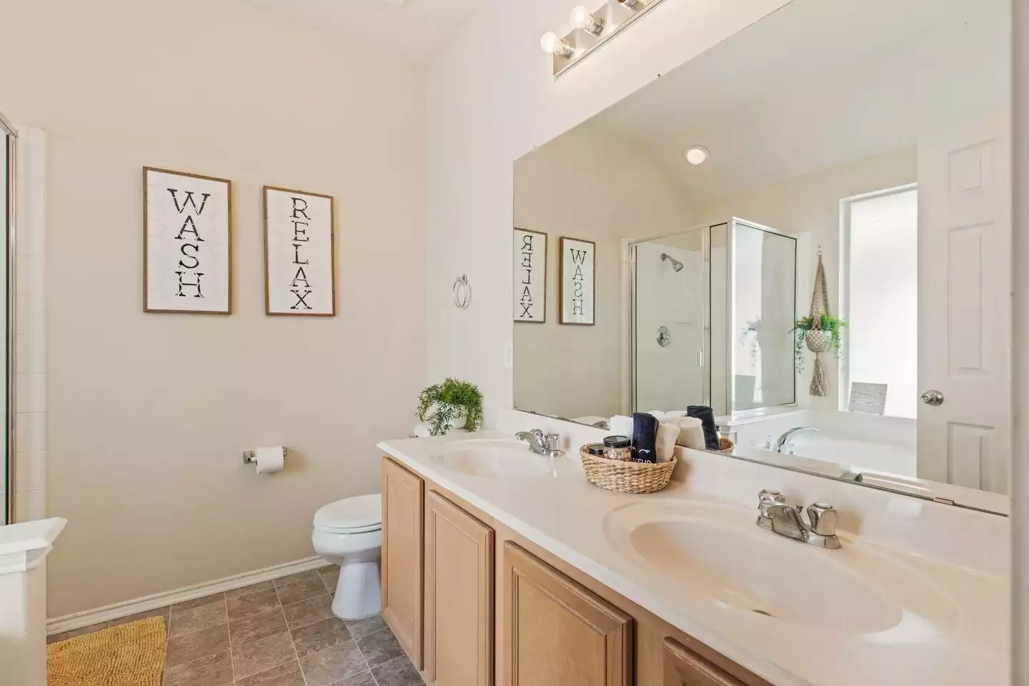 Wash and relax in our master bathroom suite that offers his and her sinks. Wash and relax in our master bathroom suite that offers his and her sinks. - The Birdhouse - Keller