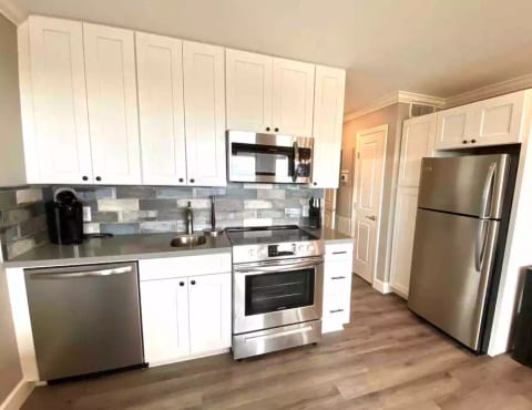 All new kitchen features full-sized stainless appliances, stone counters & custom backsplash! (Stocked with all common cooking utensils & supplies!)