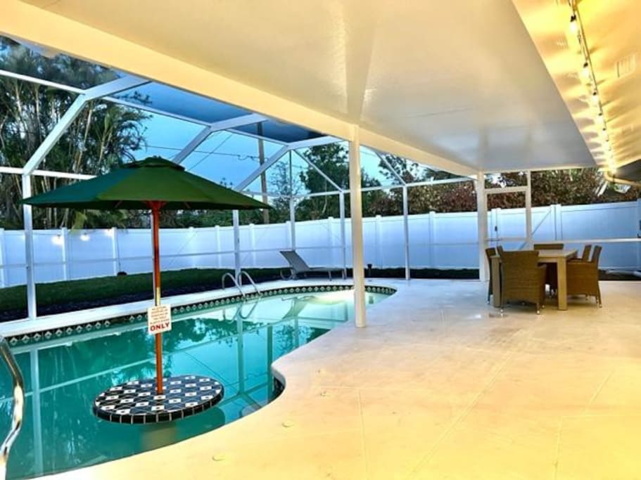 Heated pool, there is a light switch for in the pool lighting  on exterior wall of home.

Step seating around the table located in the pool. - Cape Coral 'Dog Friendly' Pool Villa - Cape Coral