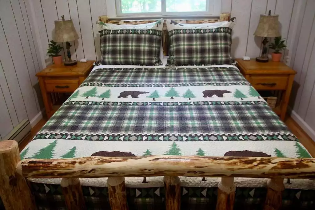 Primary bedroom with queen sized bed, bedstead charging stations, small closet, and an en suite full bathroom. Primary bedroom with queen sized bed, bedstead charging stations, small closet, and an en suite full bathroom. - Escape to a 3-Bedroom Cabin in Lower Catskills - Woodridge
