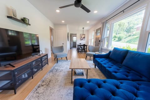 This is the main living room for our AirBnB! The 55" smart-TV is complimented by the cozy sectional, stylish chairs and lots of natural light!