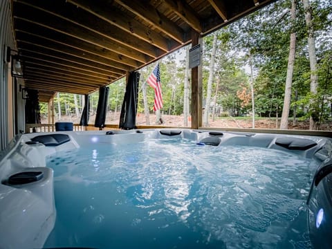 Relax & unwind in the 7-person spa  or reclining chairs, on the Front Lower Deck, while taking in the scenic nature views.