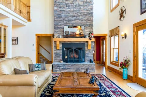 Great room with leather couches and two story rock fireplace