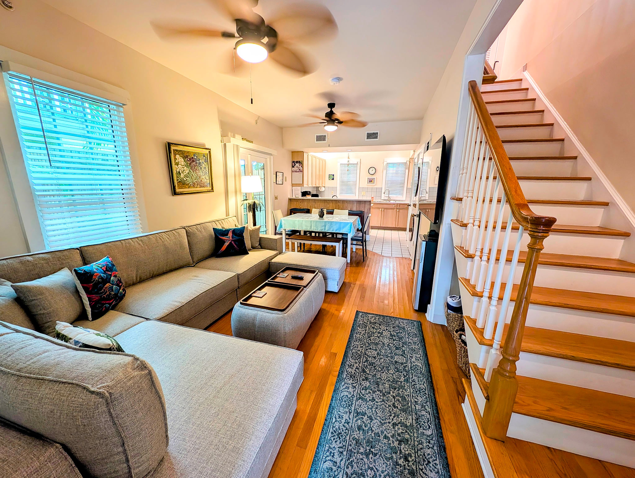 Bright open-plan living with cozy sleeper sectional, dining, and kitchen Cathouse Old Town Oasis Huge Heated Pool & Parking