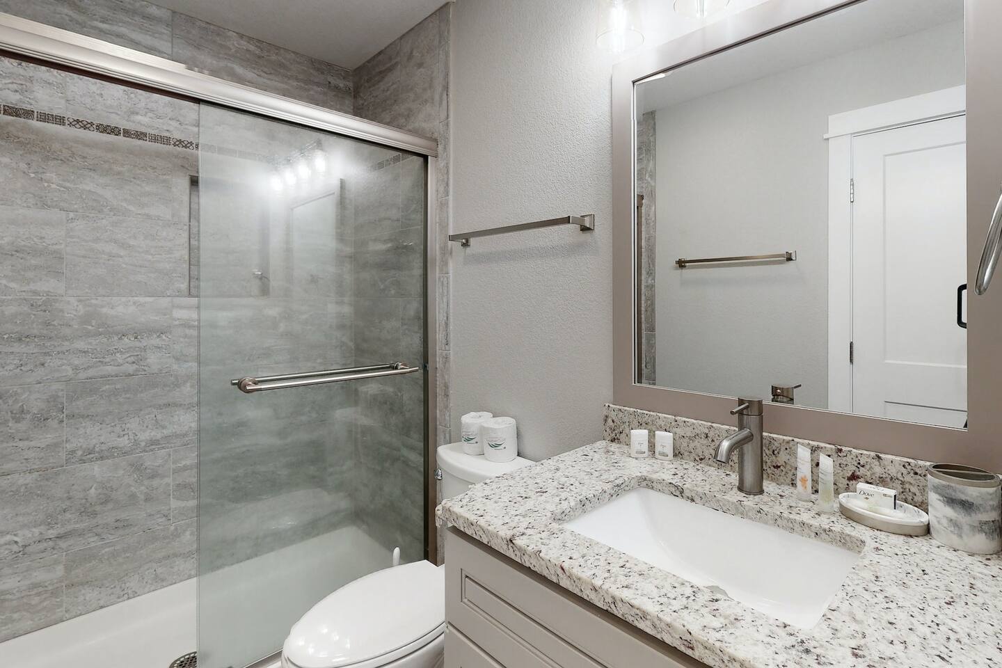 Relax and refresh in your private bath with a tiled bathtub and shower