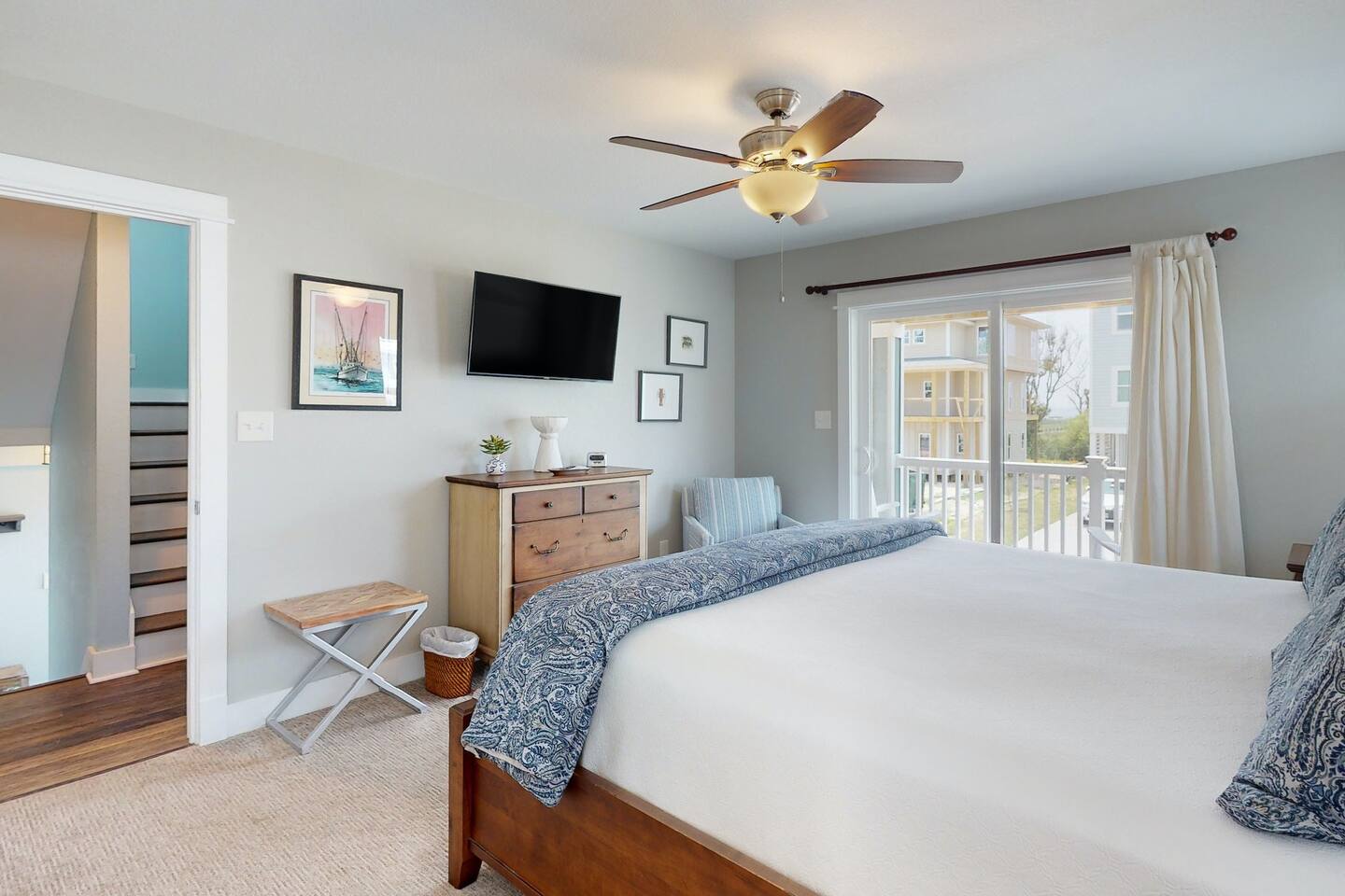 The bedroom's glass window frames tranquility and offers a window to the world outside